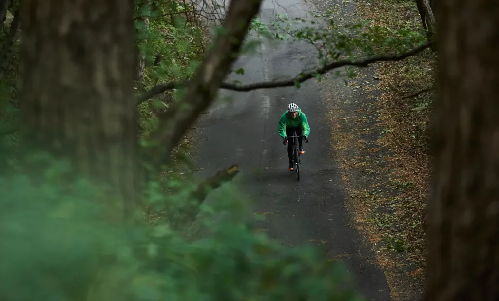 Portfolio Sport & Lifestyle del fotografo duzimage. Foto di ciclista in lontananza ripreso dal bosco.